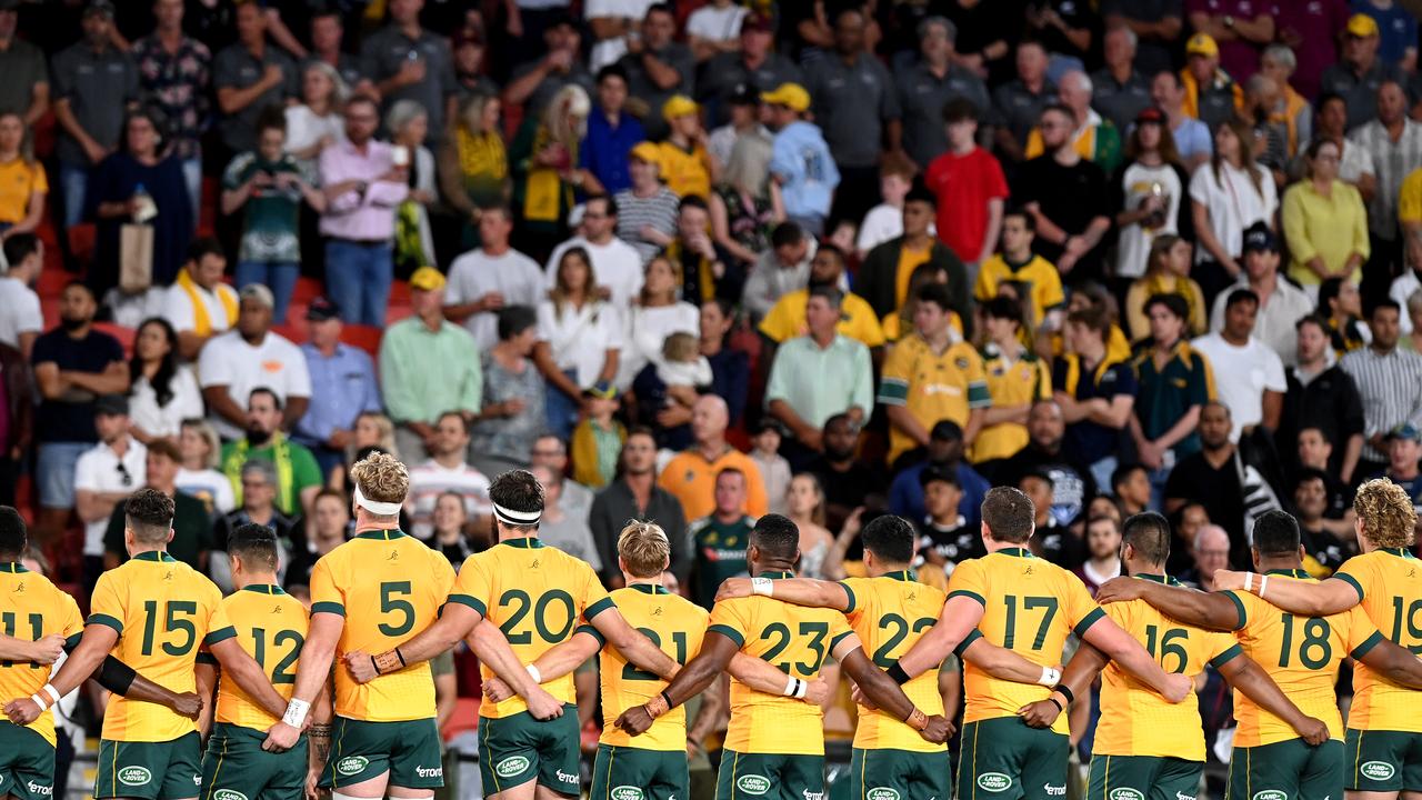 The Wallabies players embrace during the playing of the Australian National Anthem before a match against the New Zealand All Blacks at Suncorp Stadium on November 7. Picture: Bradley Kanaris/Getty Images