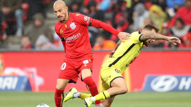 ADELAIDE, AUSTRALIA – DECEMBER 01: James Troisi of Adelaide United is challenged by David Ball of the Wellington Phoenix during the round eight A-League match between Adelaide United and the Wellington Phoenix at Coopers Stadium on December 01, 2019 in Adelaide, Australia. (Photo by Robert Cianflone/Getty Images)