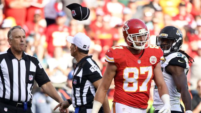 Field Judge Mike Weatherford, left, throws his cap toward Kansas City Chiefs tight end Travis Kelce (87) after Kelce, who was ejected for unsportsmanlike conduct, threw a towel in his direction during the second half.