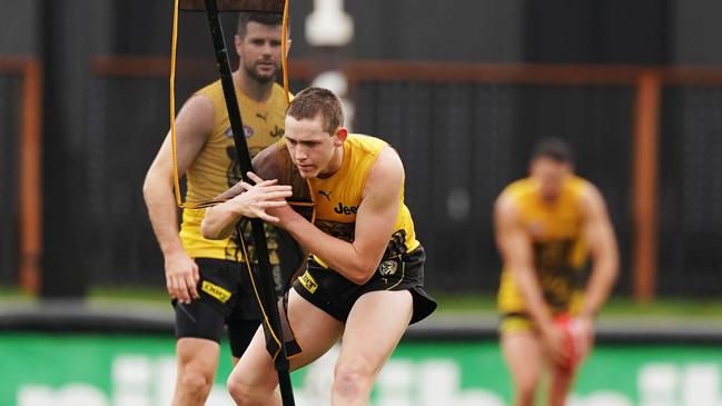 Riley Collier-Dawkins hones his tackling skills at Tigers training.