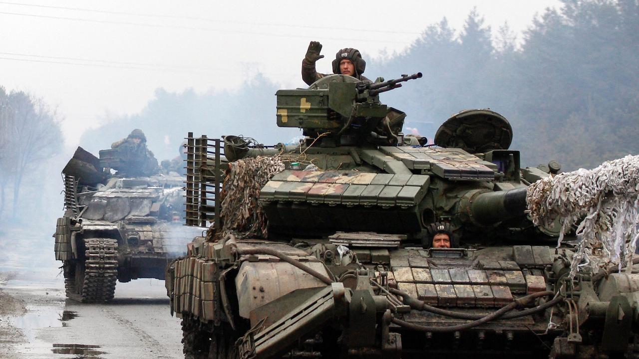 Ukrainian servicemen ride on tanks towards the front line with Russian forces in the Luhansk region of Ukraine on February 25, 2022. Picture: Anatolii Stepanov / AFP