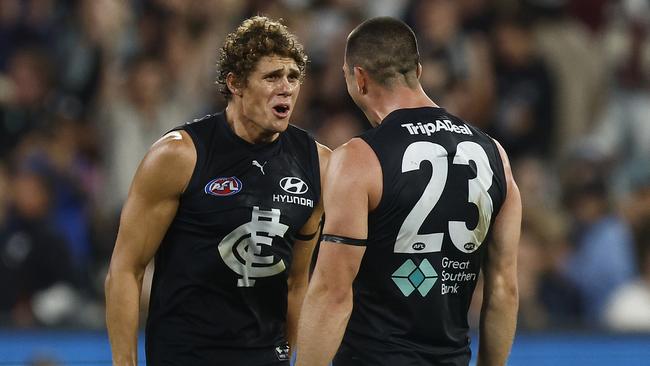 MELBOURNE, AUSTRALIA - MARCH 23: Charlie Curnow of the Blues (L) celebrates with Jacob Weitering of the Blues on the final siren after winning the round two AFL match between Carlton Blues and Geelong Cats at Melbourne Cricket Ground, on March 23, 2023, in Melbourne, Australia. (Photo by Daniel Pockett/Getty Images)