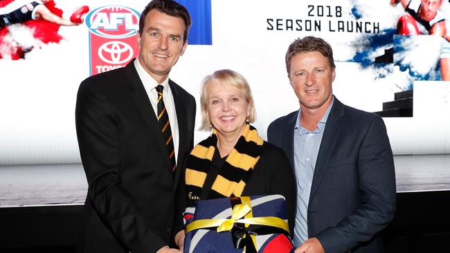 MELBOURNE, AUSTRALIA - MARCH 14: Tigers CEO Brendon Gale, Tigers President Peggy O'Neal and Tigers Senior Coach Damien Hardwick pose for a photograph with the 2017 flag during the 2018 Toyota AFL Premiership Season Launch at Forum Melbourne on March 14, 2018 in Melbourne, Australia. (Photo by Michael Willson/AFL Media)