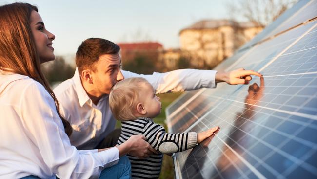 At Home 2023: March 25 issue, NEWS page inset image for main story.  Picture: iStockSide close-up shot of a young modern family with a little son getting acquainted with solar panel on a sunny day, green alternative energy concept