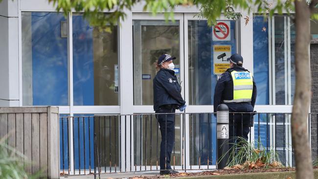 Police guard public housing towers in North Melbourne which have been locked down by the Victorian Government in an attempt to stop the outbreak of COVID-19. Picture: David Crosling