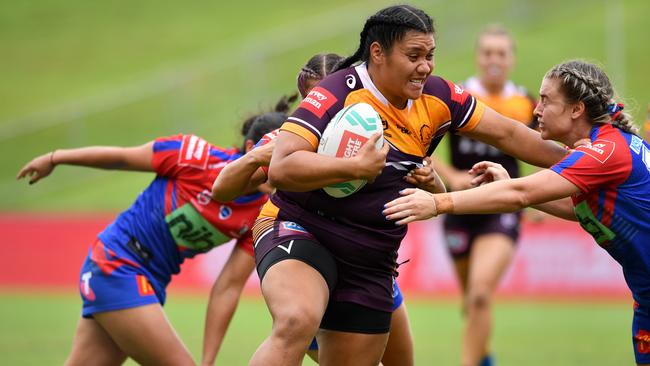 Brisbane's Amber Hall blasts through the Knights defence. NRL Imagery