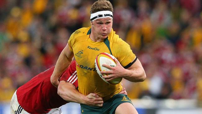 BRISBANE, AUSTRALIA - JUNE 22: Michael Hooper of the Wallabies is tackled during the First Test match between the Australian Wallabies and the British & Irish Lions at Suncorp Stadium on June 22, 2013 in Brisbane, Australia. (Photo by Cameron Spencer/Getty Images)