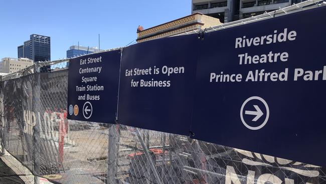 Hoardings remind pedestrians that restaurants remain open despite Parramatta Light Rail construction on Church St.