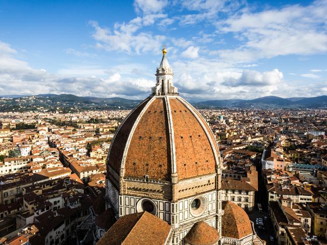 Florence, view from the Giotto Tower with the Brunelleschi dome in foreground, cityscape and blue sky. Florence Cathedral