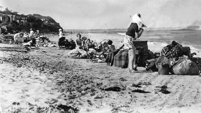 Hastily gathering together a few belongings, Torquay residents sought refuge on the beach when a bush fire swept through a section of the town in 1940.