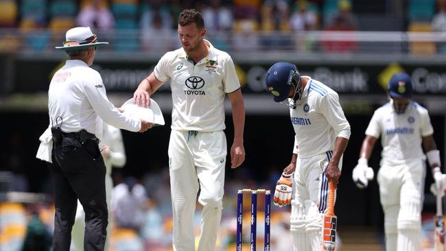 Josh Hazlewood finishes his final over before leaving the pitch with injury on Tuesday at the Gabba.