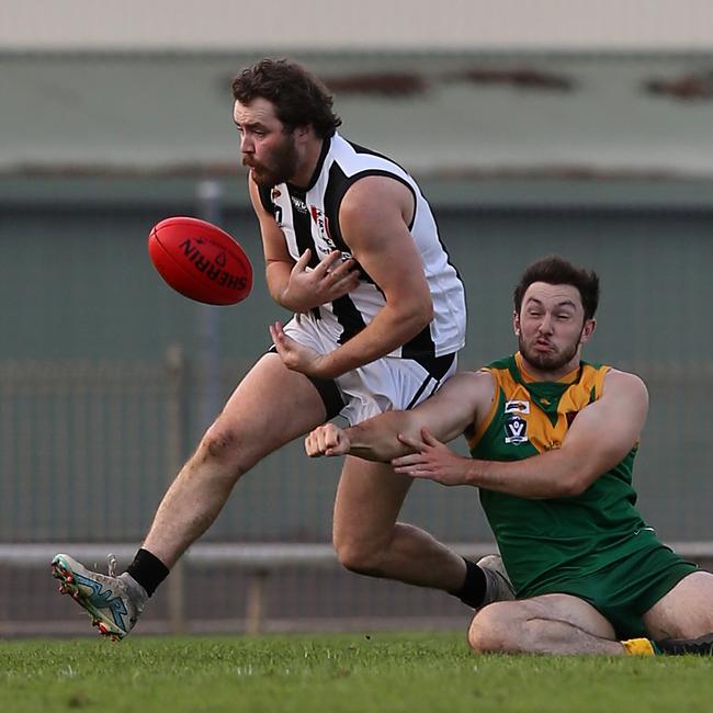 Sale’s Tom Campbell’s has marking attempt thwarted by a Leongatha opponent. Picture: Yuri Kouzmin