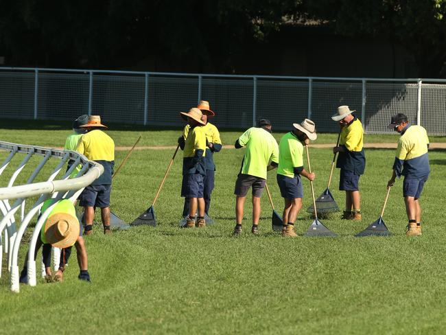 Workers repairing the track at Eagle Farm racecourse.