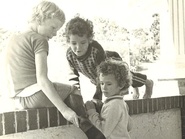 Admiring friend Martin Barmentloo’s boot with brother Cameron, on the wall, in the late 1970s.