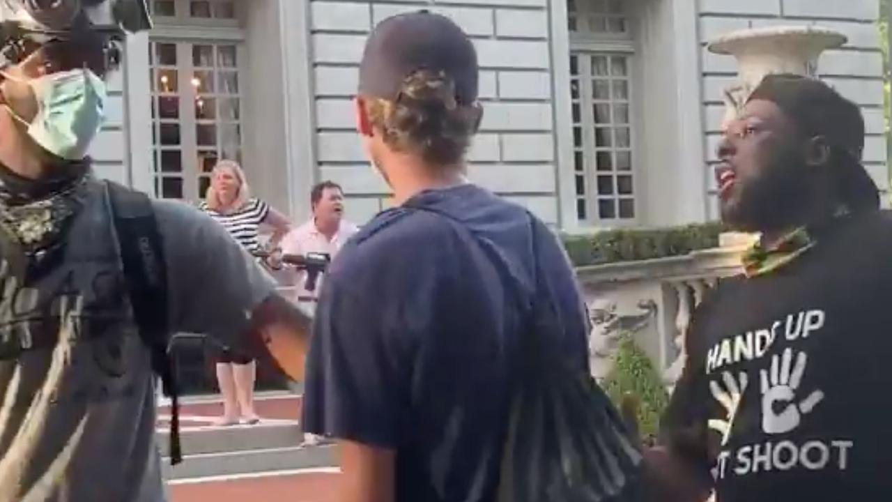 The duo were seen yelling at demonstrators. Picture: Daniel Schular/Twitter