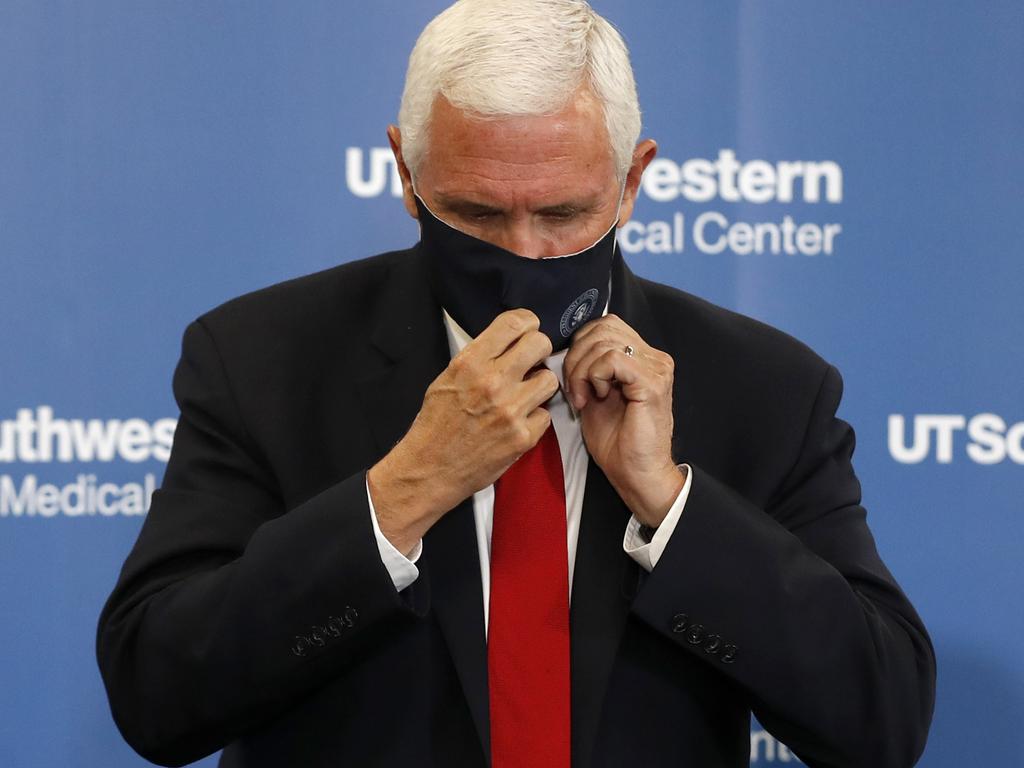 Vice President Mike Pence adjusts his mask as he prepares to depart a news conference after he met with Texas Gov. Greg Abbott. Picture: Tony Gutierrez/AP Photo