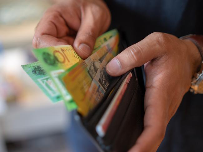 a male taking money out of the valet.