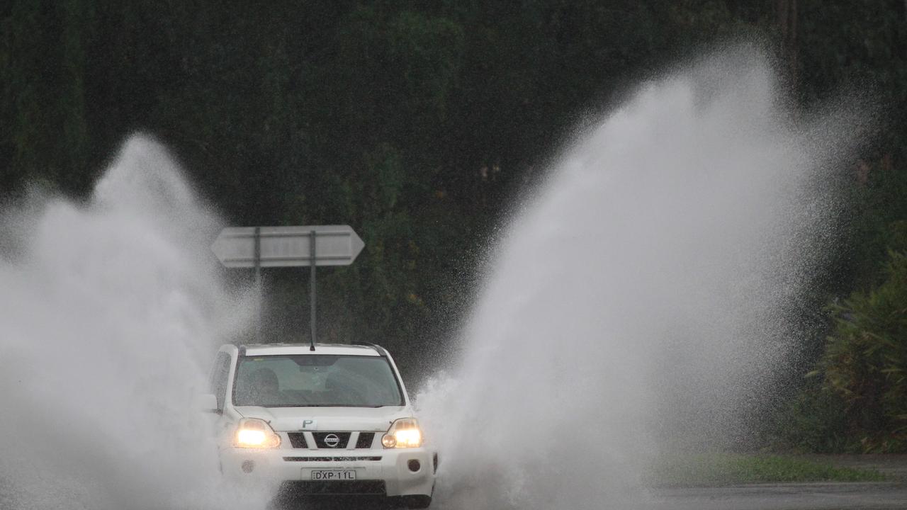 A car takes on the heavy weather. Picture: Mike Batterham