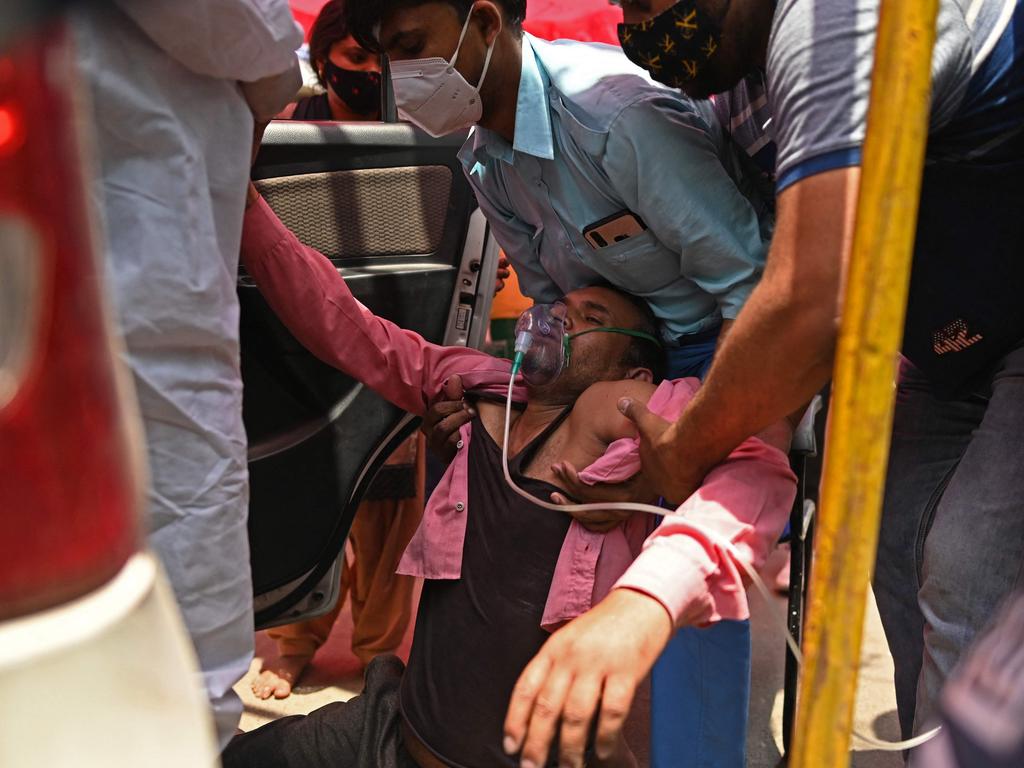 A patient breathes with the help of oxygen provided by a Gurdwara, a place of worship for Sikhs, outside a parked car along the roadside in Ghaziabad. Picture: Sajjad Hussain/AFP