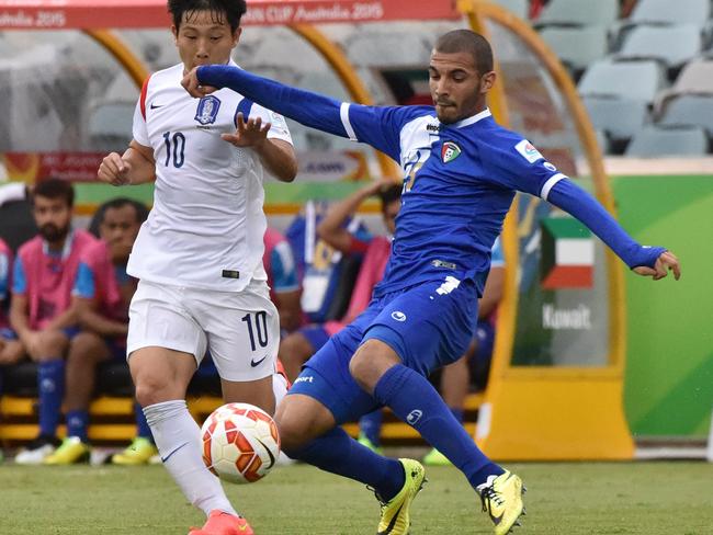 Nam Tae-Hee (L) of South Korea fights for the ball with Fahad Alhajeri (R) of Kuwait.