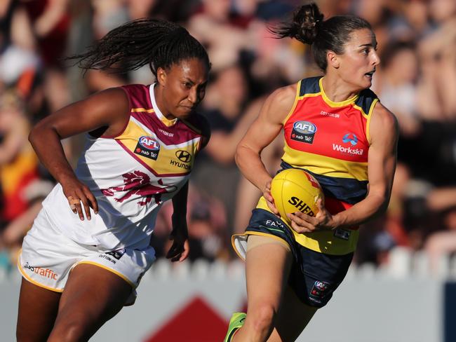 ADELAIDE, AUSTRALIA - FEBRUARY 3: Angela Foley of the Crows chased by Sabrina Frederick-Traub of the Lions during the 2018 AFLW Round 01 match between the Adelaide Crows and the Brisbane Lions at Norwood Oval on February 3, 2018 in Adelaide, Australia. (Photo by AFL Media)