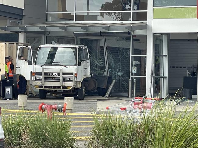 Crews have begun the clean up to remove the truck from the shopping centre entrance. Picture: Himangi Singh