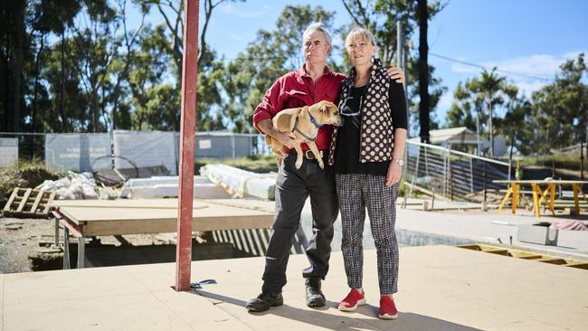 Jack Egan and Cath Bowdler, with their dog Douggy, at the home they are building in Rosedale.