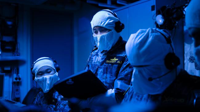 Strike Officer, Lieutenant Shafiqah Shariff Ali (centre) prepares for the test-firing of the Tomahawk missile aboard HMAS Brisbane. Picture: Defence