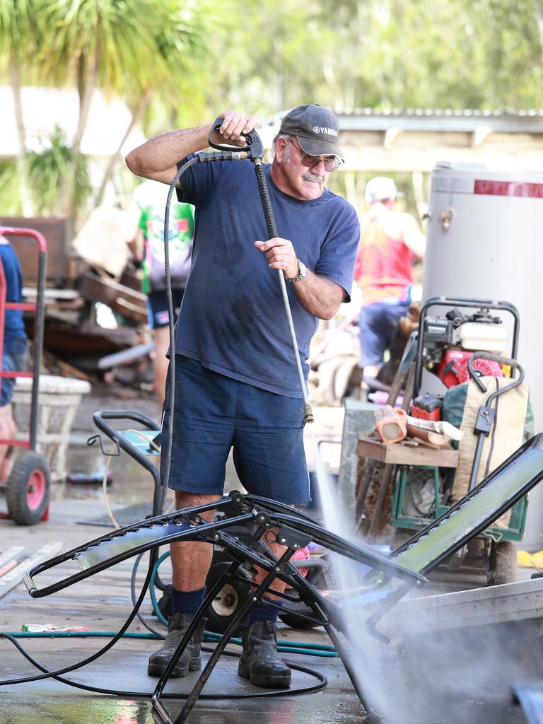 People with pressure hoses were in high demand in Eagleby in 2013. Picture: Claudia Baxter