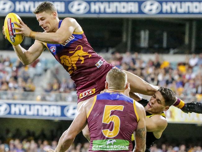 Dayne Zorko marks over Dion Prestia.