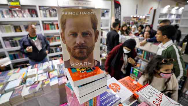 Shoppers browse books behind a copy of Spare by Britain's Prince Harry at a stall at the 54th Cairo International Book Fair in Egypt's capital on January 29, 2023. Picture: Khaled Desouki/ AFP)