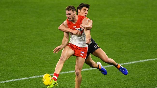 Swan Jackson Thurlow is tackled by Giant Jye Caldwell during their match at Optus Stadium. Picture: Daniel Carson/AFL Photos via Getty Images