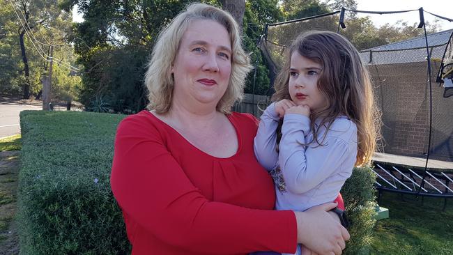 Catherine and her three-year-old daughter, who has special needs, at the front of their Ringwood East home. Picture: Kiel Egging.