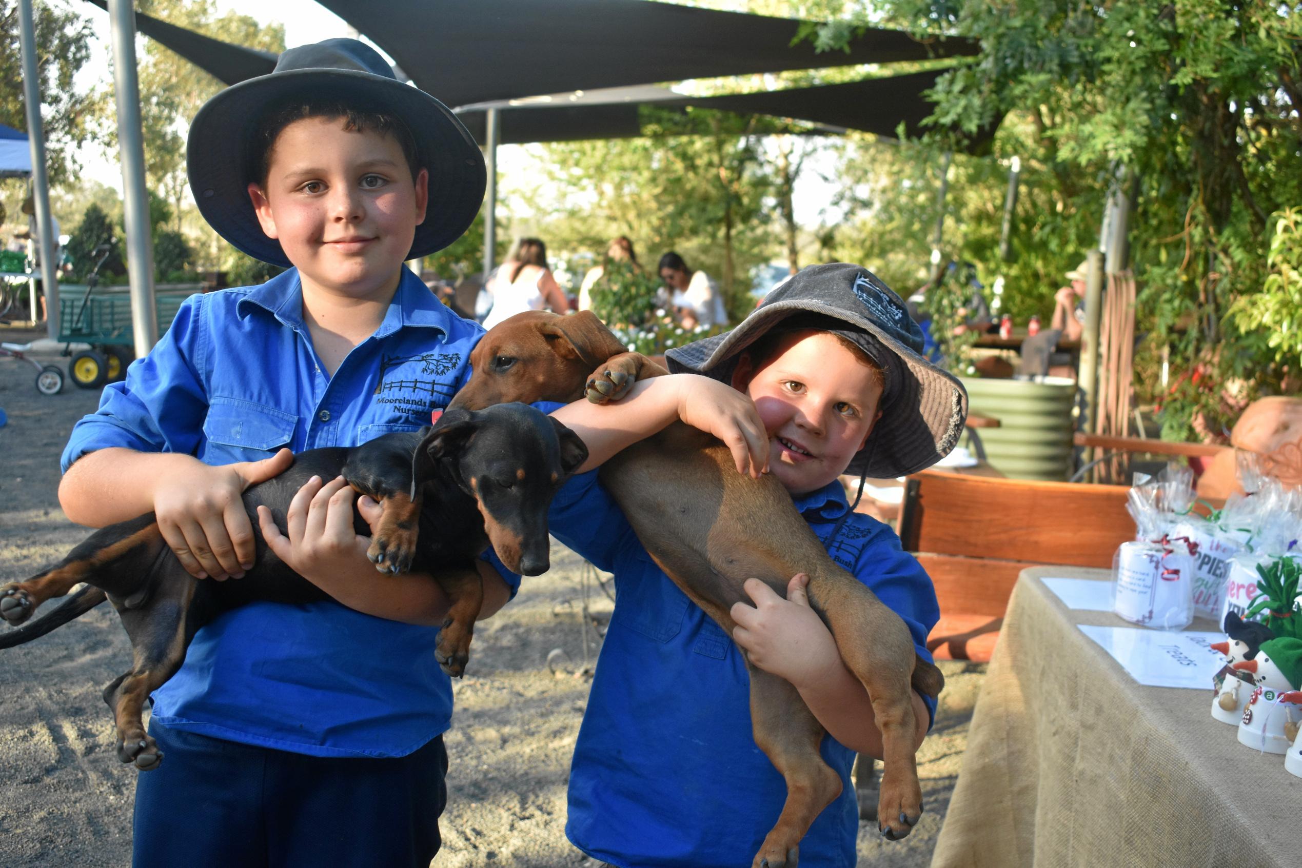 Jack and Geoff Murray with their little helpers. Picture: Ellen Ransley