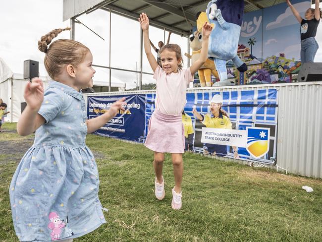 (from left) Bella McGrath and Phoebe Evans dance during the Bluey show at the Toowoomba Royal Show. Saturday, March 26, 2022. Picture: Nev Madsen.