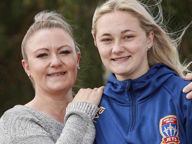 ***EMBARGO CHECK WITH DT PIC DESK BEFORE USE***  Susie Abberfield with her daughter Paige, 15, in Barnsley, NSW, today.Young footballer Paige Abberfield was hit by a four-wheel drive last year, dragged underneath and had multiple injuries. Her surgeon said she'd never play again. After weeks in hospital, more on crutches and months of rehab, she came off the bench a few weeks ago for Newcastle Jets' U15 team and scored twice. Picture:Justin Lloyd.