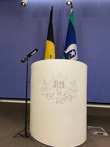 The Australian flag was moved to the side of the room prior to Greens leader Adam Bandt conducting a press conference. Picture: Twitter/isobelroe