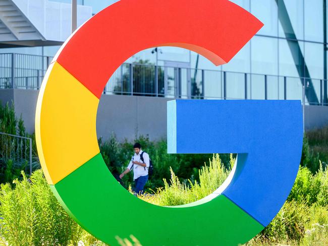 (FILES) A worker walks along a path at Googleâs Bay View campus in Mountain View, California on June 27, 2022. Google parent Alphabet on October 24, 2023 reported a quarterly profit of $19.7 billion powered by money taken in from ads, YouTube, and cloud services. (Photo by NOAH BERGER / AFP)