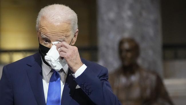 US President Joe Biden wipes his eyes as he listens to Vice President Kamala Harris speak on the one-year anniversary of the January 6 attack on the US Capitol. Picture: AFP