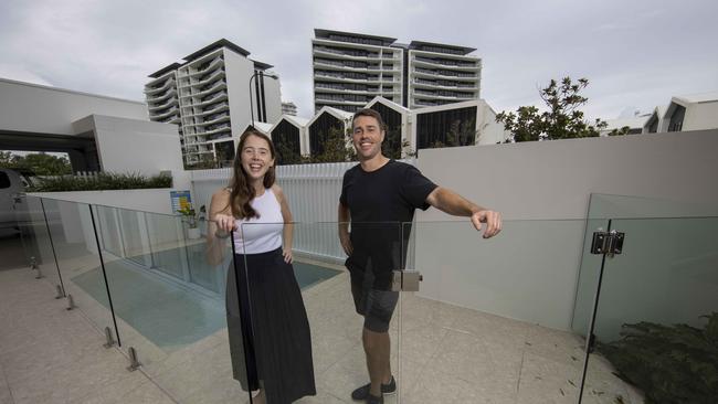 Ryan Sanderson and wife Laura Cartledge, outside their recently purchased house on the Gold Coast, are among thousands of people leaving Melbourne to escape the Covid restrictions. Picture: Glenn Hunt / The Australian