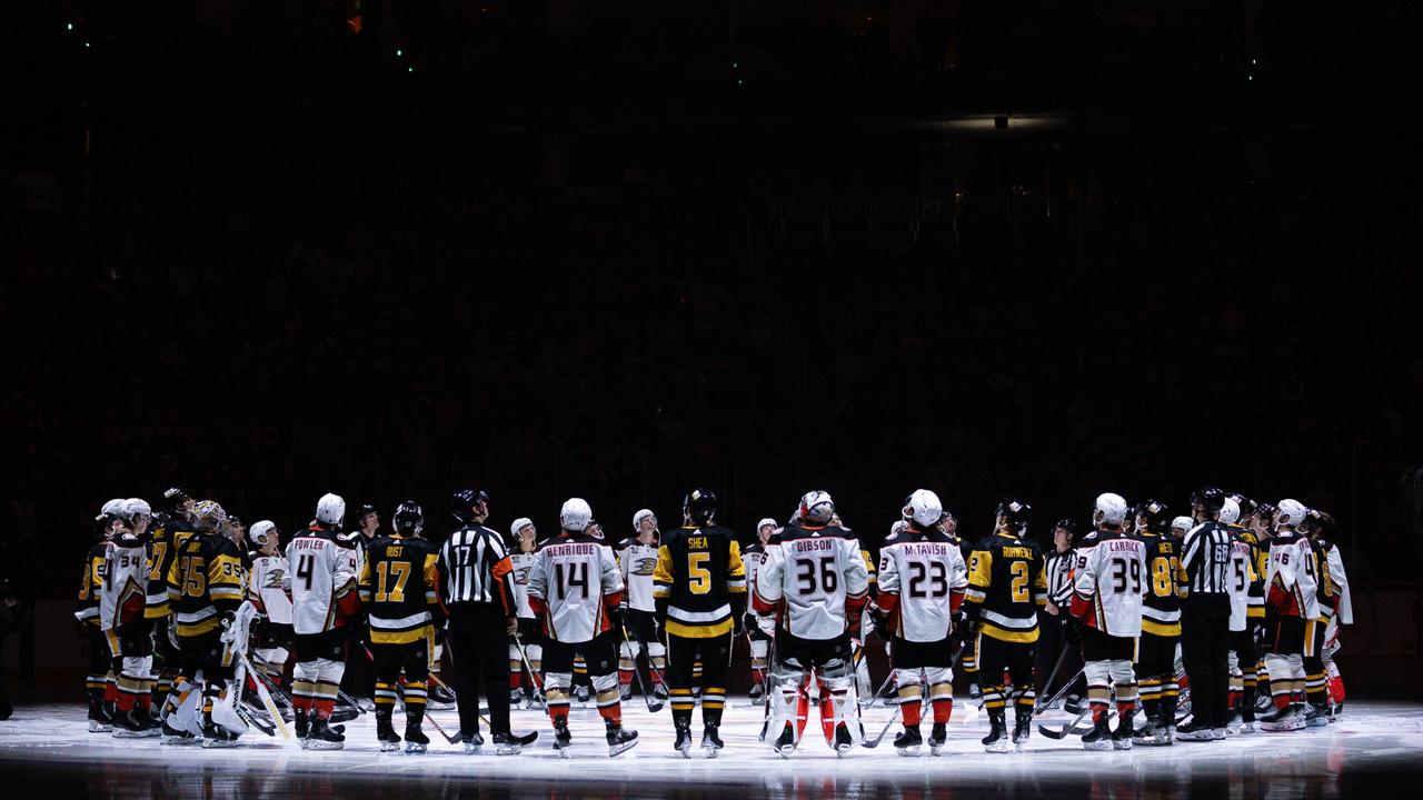 Pittsburgh Penguins and Anaheim Ducks players stand for a moment of silence following the death of former Penguins player Adam Johnson, prior to their game at PPG PAINTS Arena. (Photo by Harrison Barden/Getty Images)