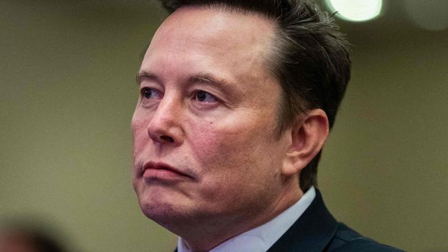 TOPSHOT - Elon Musk listens as US President-elect Donald Trump speaks during a meeting with House Republicans at the Hyatt Regency hotel in Washington, DC on November 13, 2024. (Photo by Allison ROBBERT / POOL / AFP)