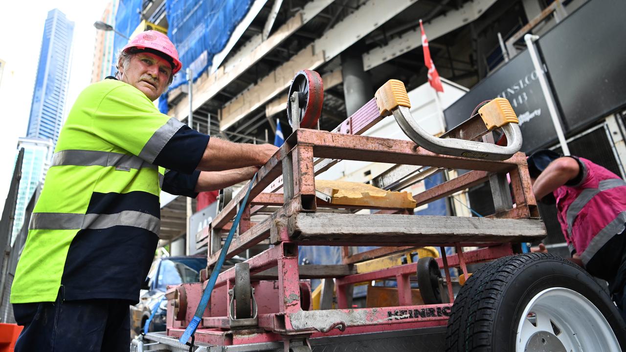 Sub-contractors and tradesmen pack up their equipment and walk off Probuild’s construction site at 443 Queen St when the company went into administration earlier this year.