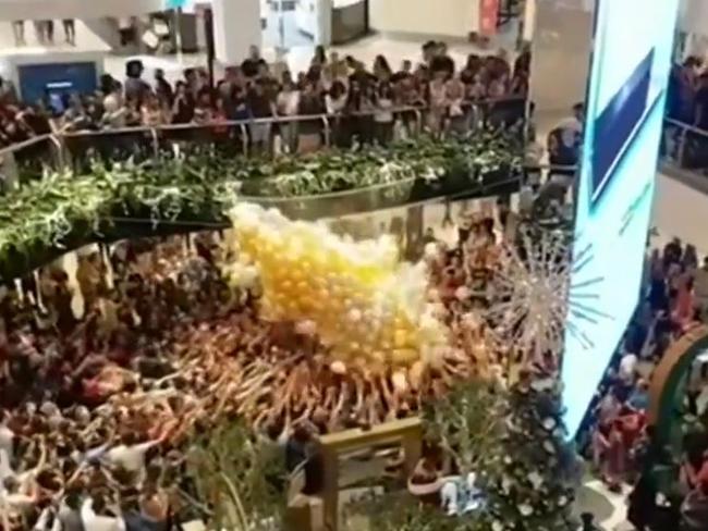 Shoppers rush to grab freebies contained in balloons at Westfield Parramatta. Picture: 9 News