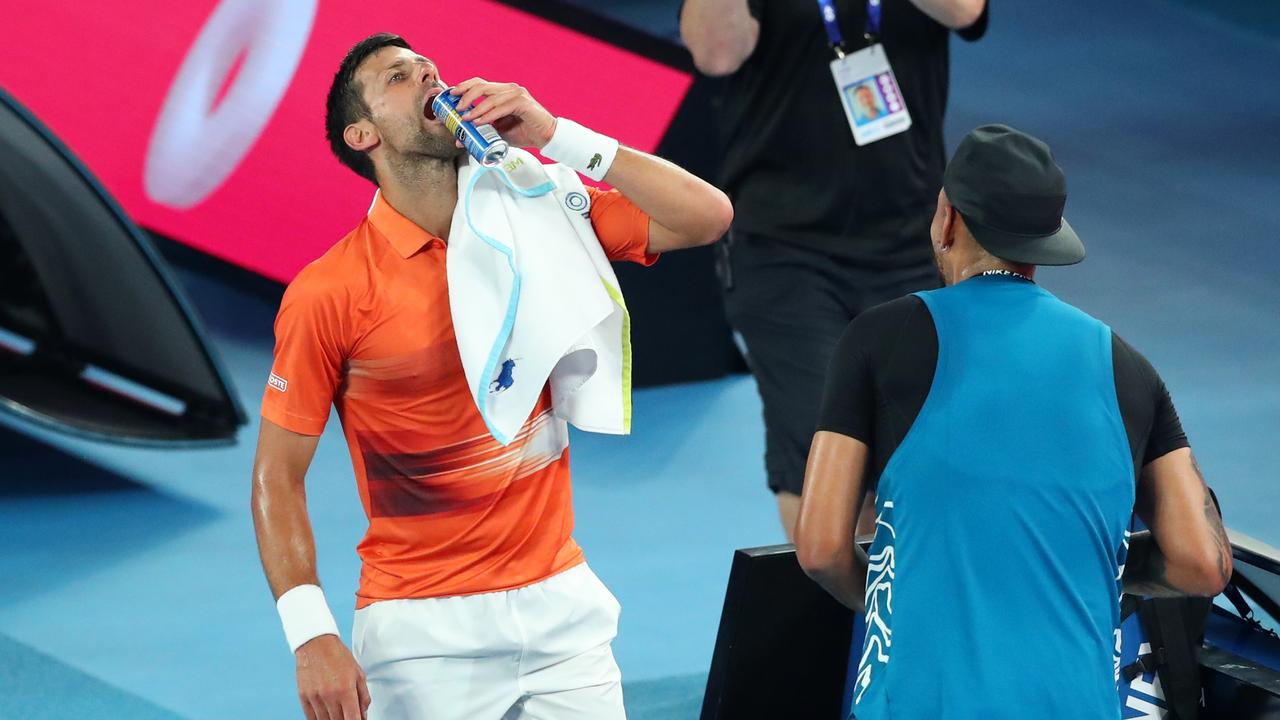 Djokovic has a drink with Kyrgios between games. Picture: Getty