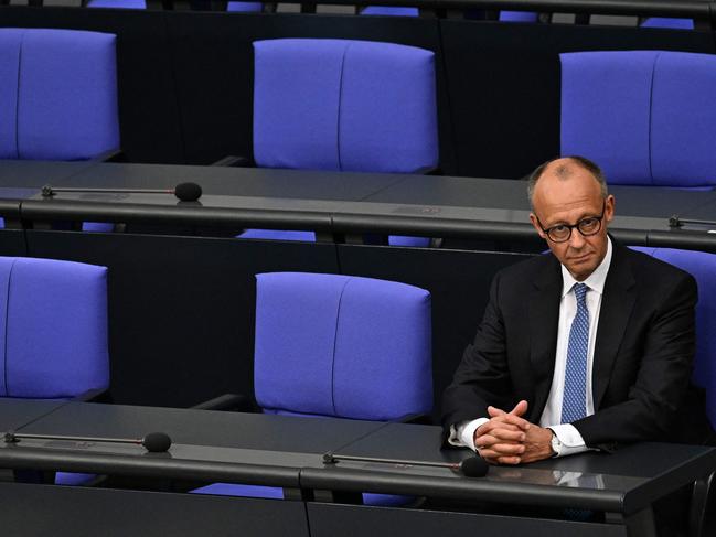 Newly elected German Chancellor Friedrich Merz sits alone on the Chancellor's seat after taking the oath during a swearing in session after a second round of voting at the Bundestag in Berlin. Picture: AFP