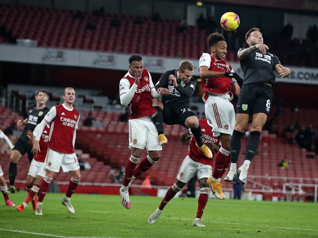 Arsenal's Gabonese striker Pierre-Emerick Aubameyang (2nd R) heads the ball toward the goal and into his own net to score an own goal during the English Premier League football match between Arsenal and Burnley at the Emirates Stadium in London on December 13, 2020. - Burnley won the game 1-0. (Photo by Nick Potts / POOL / AFP) / RESTRICTED TO EDITORIAL USE. No use with unauthorized audio, video, data, fixture lists, club/league logos or 'live' services. Online in-match use limited to 120 images. An additional 40 images may be used in extra time. No video emulation. Social media in-match use limited to 120 images. An additional 40 images may be used in extra time. No use in betting publications, games or single club/league/player publications. /