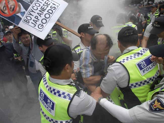 Protesters scuffle ... with police during a demonstration as South Korea marks the 70th Independence Day in front of Japanese embassy. Picture: Getty