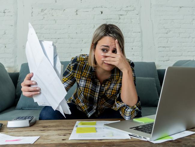 Portrait of desperate young woman feeling stressed checking online banking accounting home finances not able to pay off debts, mortgage, rent and expenses. In paying bills and financial problems.