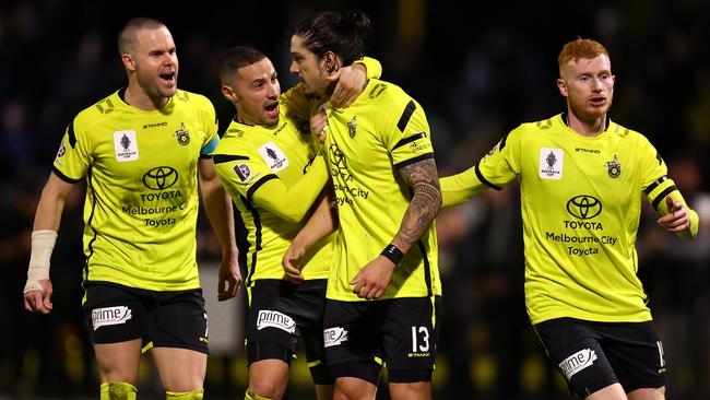 Kosta Petratos celebrates his goal with Heidelberg United teammates.